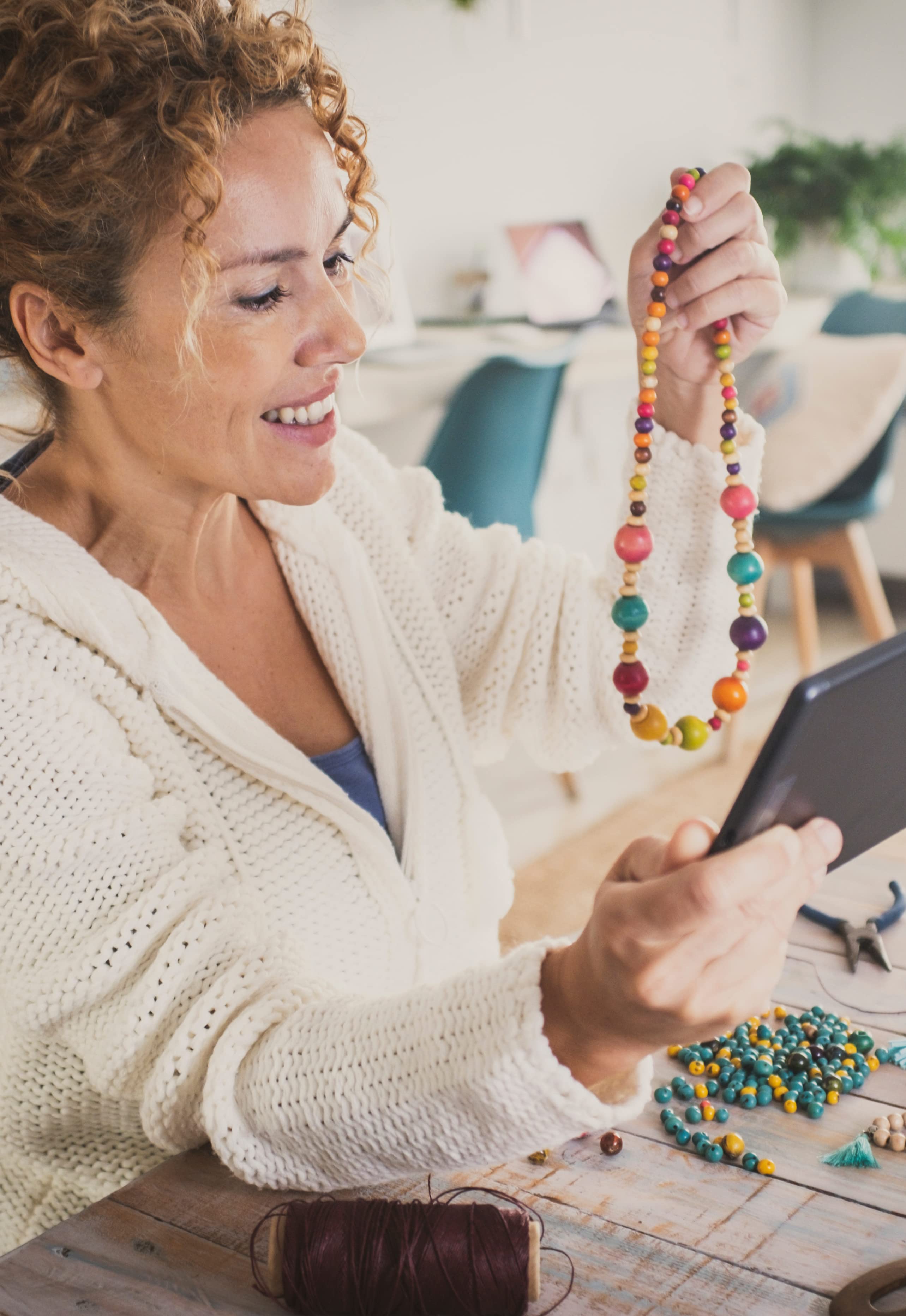 Image shows a woman starting an online jewellery business by advertising her products online.