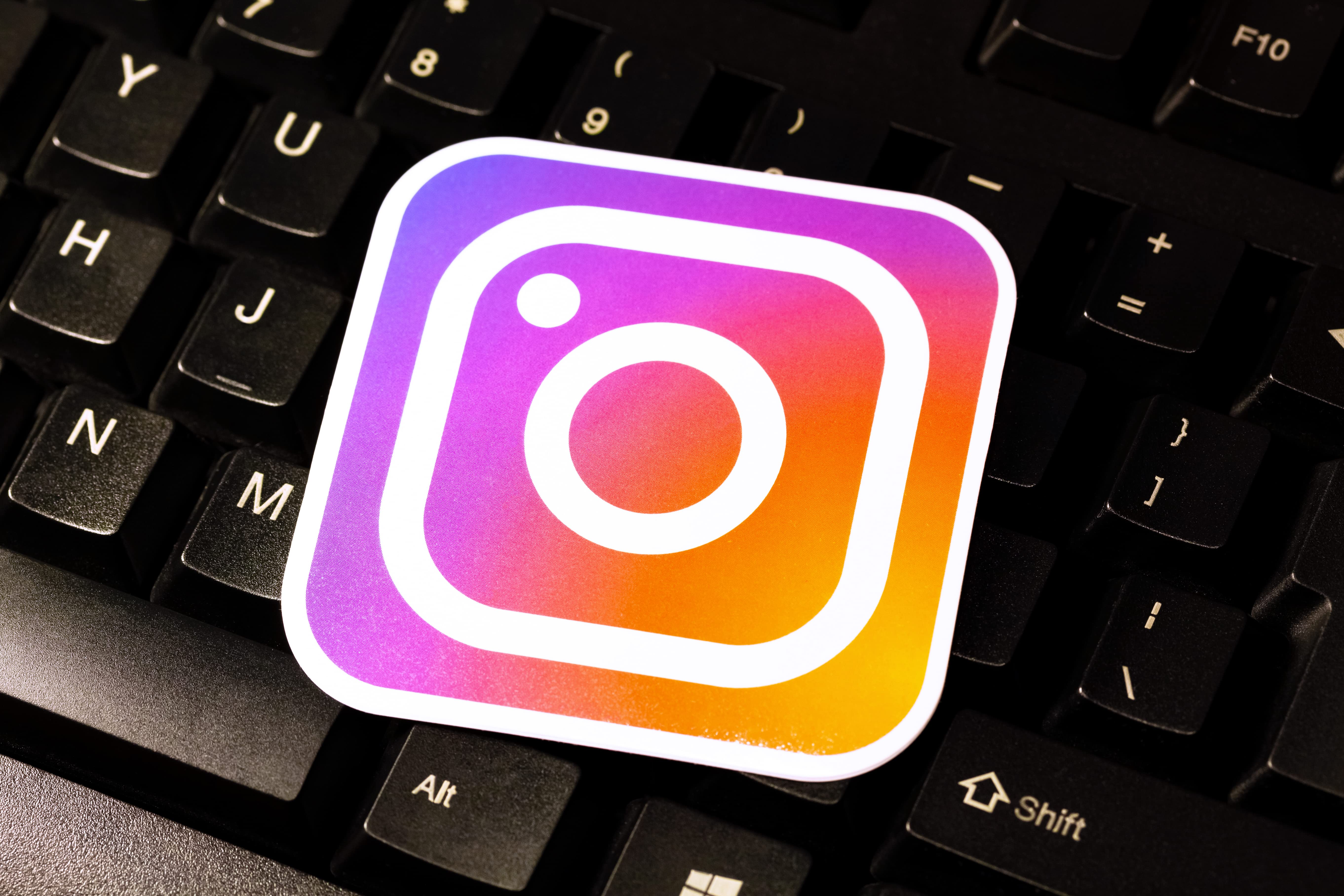 Image shows the logo of instagram on a keyboard- Types of instagram ads.